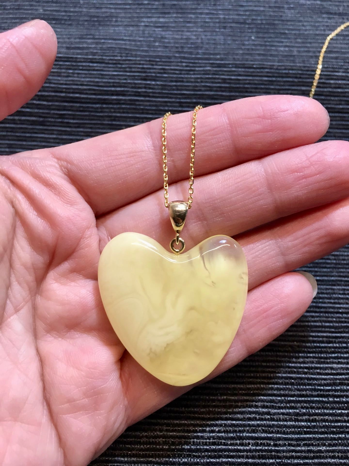 Handmade asymmetrical heart pendant made of genuine Baltic white amber with floating patterns 925 pendant without a chain